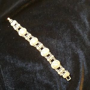 Silver tone with old fashioned floral motif